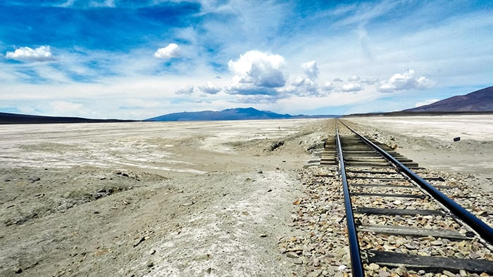 Desert landscape with railway tracks under a blue sky at LDV Vision Summit.
