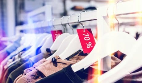Clothing rack showcasing 70% off sale on fashion apparel at Kaptur store.