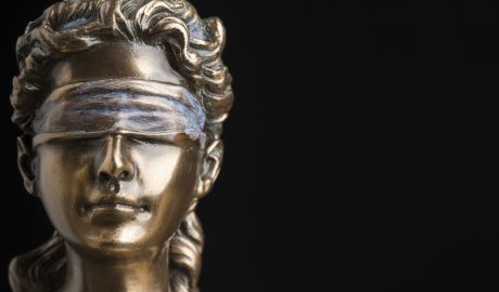 Style sculpture of a woman with a blindfold, symbolizing ethics and perception in AI discussions.