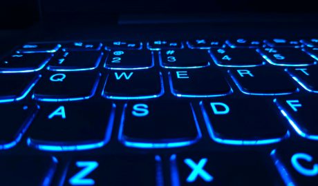 Close-up of illuminated blue keyboard keys highlighting digital security.