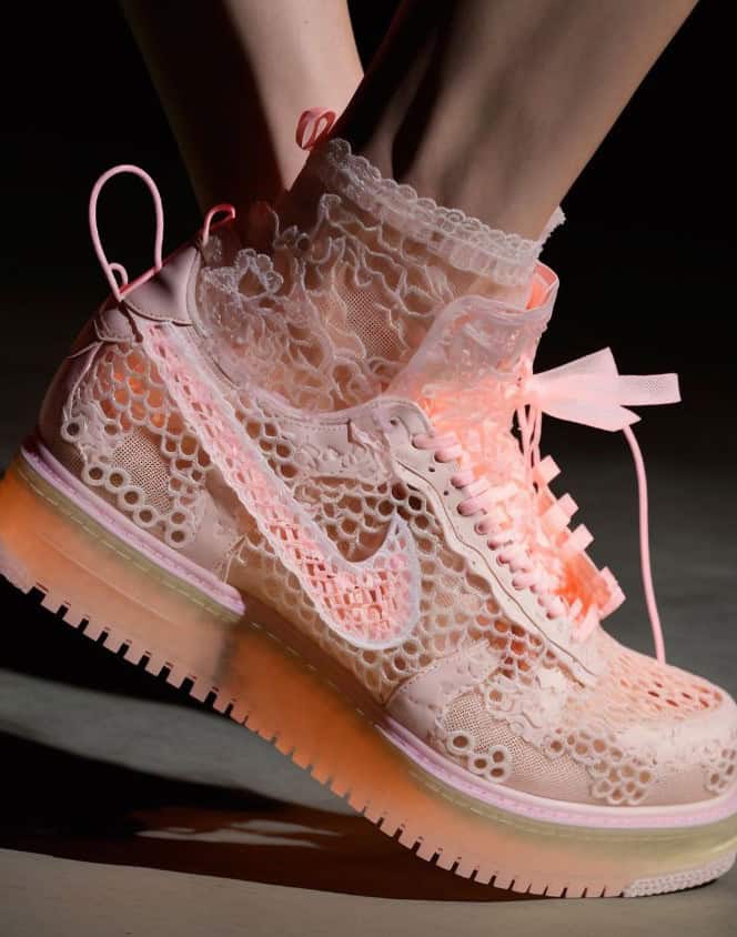 Up of pink lace sneakers with lace socks, emphasizing authenticity and style.