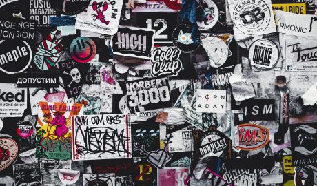 Colorful collection of stickers and graffiti highlighting the tension between text and visuals.