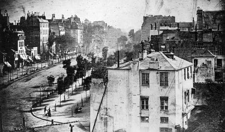 Black and white historical cityscape with buildings and streets.