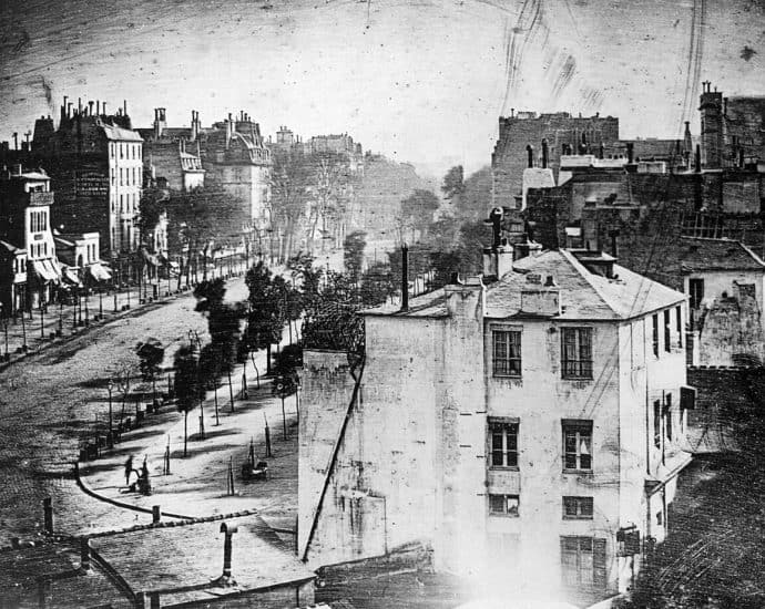 Black and white historical cityscape with buildings and streets.