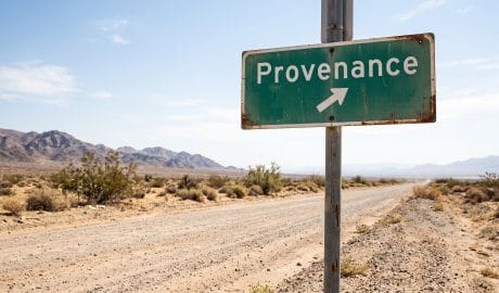 Road sign pointing to Provenance in a desert setting with mountains in the background.