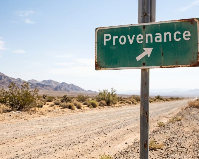 Road sign pointing to Provenance in a desert setting with mountains in the background.