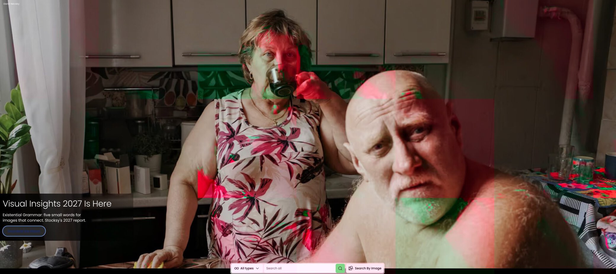 Two people in a kitchen with red and green lighting, candid scene.